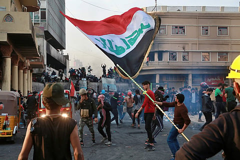Anti-government protesters gather on Rasheed Street during clashes with security forces in Baghdad, Iraq, Thursday, Nov. 28, 2019.  (Photo | AP)