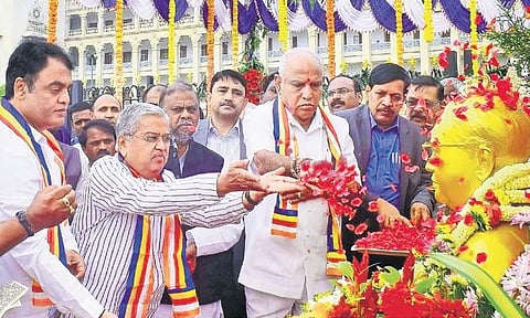 Chief Minister B S Yediyurappa pays floral tribute to the statue of Dr B R Ambedkar to commemorate his 63rd death anniversary, in Bengaluru on Friday | pandarinath B