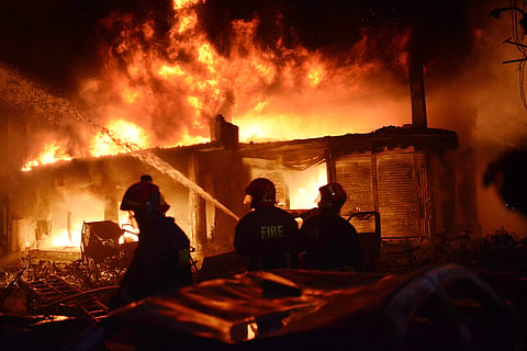 In this Wednesday, Feb. 20, 2019, photo, firefighters try to douse a fire in Dhaka, Bangladesh. (Photo | AP)