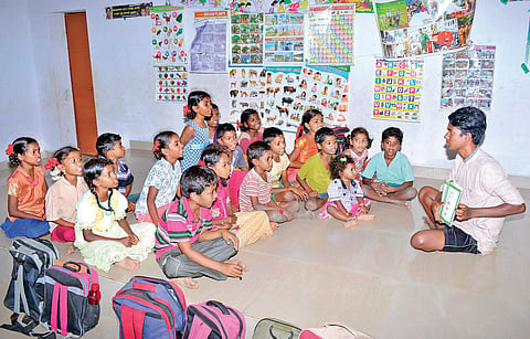 C Jayaraj, an undergraduate student and resident of Samy Nagar dedicatedly teaching children from the community. | Express
