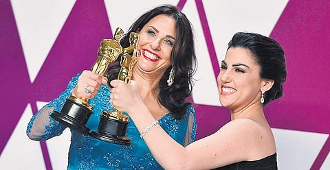 Melissa Berton (L) and Rayka Zehtabchi with their Oscar for the Best Documentary (Short Subject), for Period. End of Sentence, in Los Angeles on Tuesday | AP