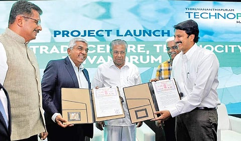 Hrishikesh Nair, CEO, IT Parks Kerala, exchanging the MOU with Brigade group chairman M R Jaishankar in the presence of Chief Minister Pinarayi Vijayan | Express