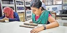 Research scholars going through the palm leaf manuscript kept at Sanskrit University