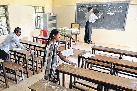 Invigilators get a classroom ready for PU II exams at GPU College for Girls in Basavangudi on Thursday | Nagaraja Gadekal