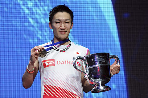 Kento Momota of Japan poses with his trophy after defeating Viktor Axelsen of Denmark in the Men's Singles final match at the All England Open Badminton tournament in Birmingham. (Photo | AP)