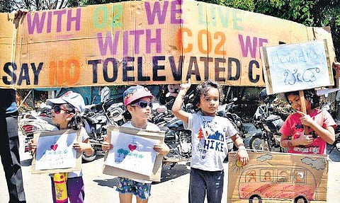 Children with placards join the protest against the proposed elevated corridor project at Maurya Circle in Bengaluru on Saturday. (Photo | Pushkar V, EPS)