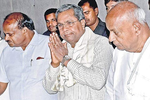 CM H D Kumaraswamy, Congress leader Siddaramaiah and JD(S)patriarch  H D Deve Gowda at a press conference. (File | EPS)