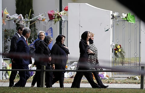 New Zealand Prime Minister Jacinda Ardern  walks past Al Noor mosque as she arrives for Friday prayers at Hagley Park in Christchurch, New Zealand, Friday, March 22, 2019. People across New Zealand are observing the Muslim call to prayer as the nation ref