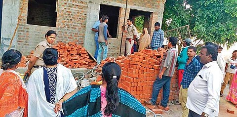 People gather around the construction site at KR Puram where two minor kids drowned in a water sump on Thursday | Express