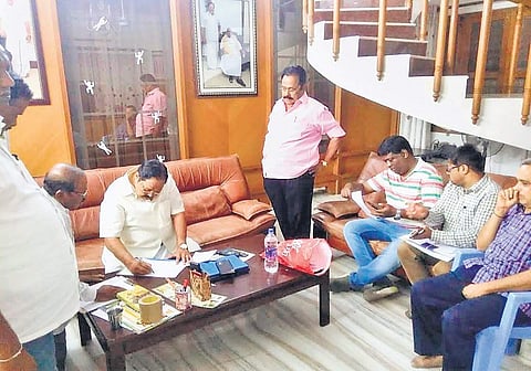 DMK treasurer Durai Murugan examining the papers, the Income Tax officials produced during an attempt to raid his house, in Katpadi on Friday night | Express Photo Services