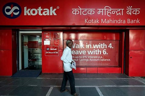 A man walks past the Kotak Mahindra Bank branch in New Delhi, India, September.  (Photo | Reuters)