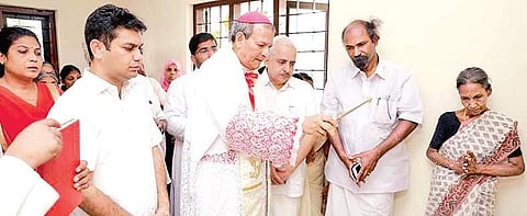 Verapoly Archbishop Joseph Kalathiparambil conducting the blessing ceremony of a house  Express