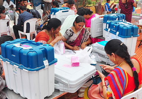 Election staff checking the EVMs and voters' list before transporting them to the polling stations at AU Engineering Grounds in Visakhapatnam on Wednesday.