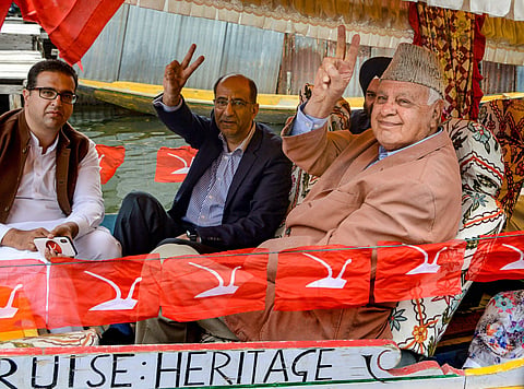 National Conference President and party candidate Farooq Abdullah shows victory sign from Dal Lake in Srinagar (Photo | PTI)