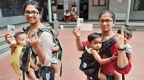These new age mothers carried their babies with them to cast their votes at Mamudan block in Bengaluru's Basavanagidi constituency  (Photo | Nagaraja Gadekal, EPS)