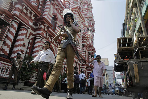 A Sri Lankan police officer patrols out side a mosque in Colombo (Photo|AP)