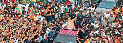 Prime Minister Narendra Modi waves to the crowd during a mega roadshow in Varanasi on Thursday. He is seeking re-election to Parliament from this temple city of Uttar Pradesh | AP