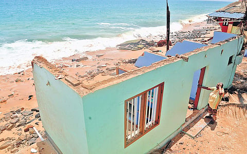 Mariyamma Manuel, from Valiyathura in Thiruvananthapuram, is desolate on finding that her house is damaged heavily by rough waves on Thursday  | Vincent Pulickal