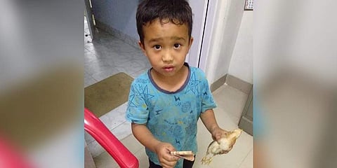 The photo of Derek C Lalchhanhima and the chicken that went viral on social media