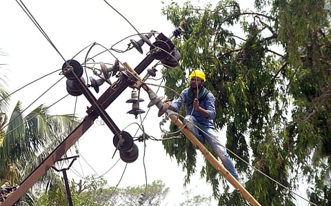 An electrician repairs a damaged power pole in Bhubaneswar. (Photo| Biswanath Swain/EPS)