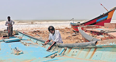 Fishermen repairing their boats at Penthakata in Puri | Irfana