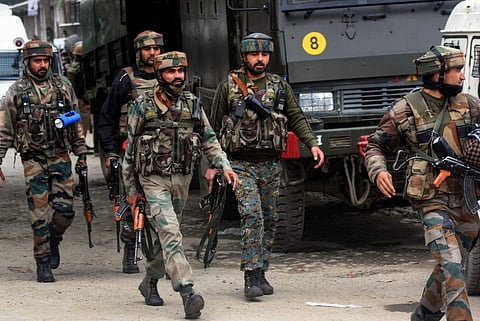Army soldiers move near the house militants were hiding during an encounter in Pulwama (Photo | PTI)