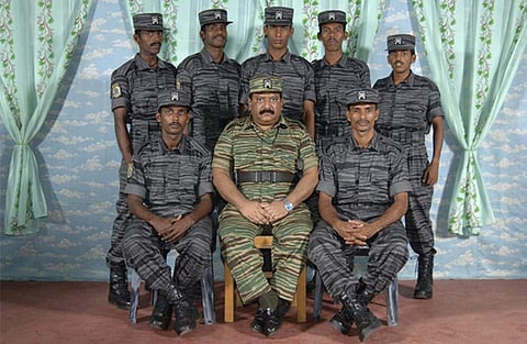 In this undated handout photograph made available by rebel Liberation Tigers of Tamil Eelam (LTTE), LTTE leader Velupillai Prabhakaran, center, poses for a group photograph with Tamil rebels in Anuradhapura, about 210 kilometers (130 miles) northeast of C