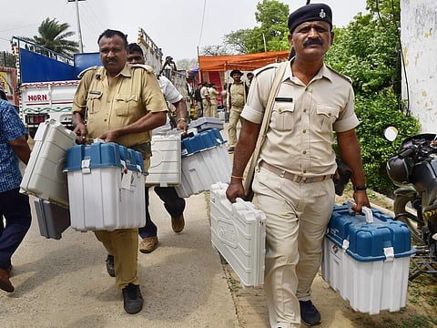 Security officials taking Electronic Voting Machines and other election material to strong rooms. (Photo | PTI)
