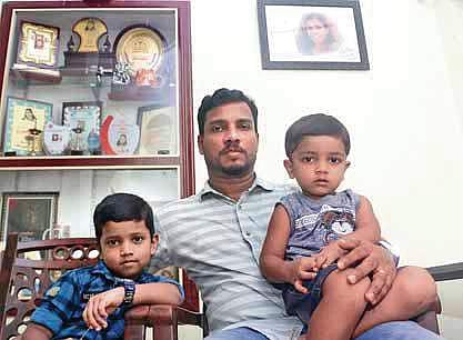 Lini’s husband Sajeesh with their children Rithul and Siddharth at Lini’s house in Chembanoda near Perambra in Kozhikode | T P Sooraj