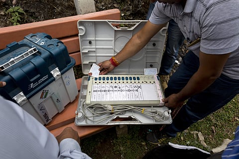 A polling officer checks an electronic voting machine before moving towards his allotted booth in Dharmsala, India, Friday, May 17, 2019.  | AP