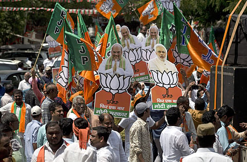BJP supporters participate in a victory rally. (Photo | AP)