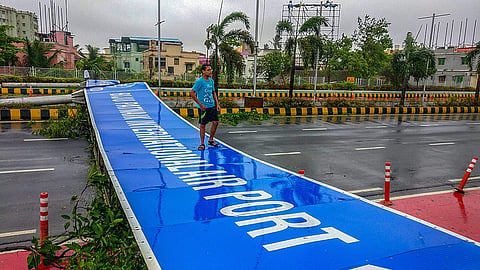 A wind-uprooted signboard lies on the road after Cyclone Fani made landfall in Bhubaneswar on Friday. (Photo | PTI)