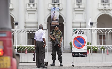 A Sri Lankan army soldier stands guard at the entrance to a closed Catholic church in Colombo where services are canceled for a second weekend in after the government warned of more possible attacks by the same Islamic State-linked group that carried out 