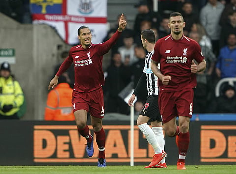 Liverpool strike late to go top, nine-man Spurs beaten at Bournemouth