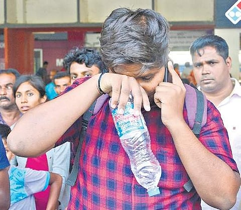 A NEET aspirant breaks down after missing the test due to delayed train arrival in Bengaluru. (Photo | ENS/Shriram B N)