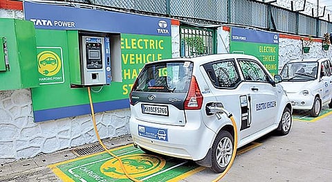 An electric vehicle replenishing charge at a charging stations. 