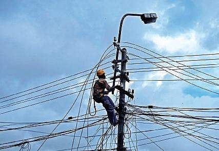 A KSEB worker engaged in work at Rajaji Nagar in the cityB P Deepu