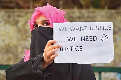 A woman investor protests outside the Police Commissioner’s office in the city on Tuesday;