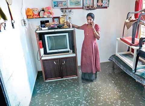 A resident at a flooded home in Chellanam | ARUN ANGELA