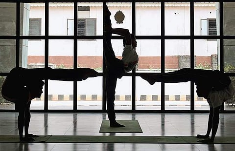 Students performing yoga on the campus of Rajiv Gandhi University of Knowledge Technologies (RGUKT-IIIT) in Nuzvid. (Photo | P Ravindra Babu, EPS)