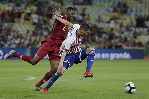 Paraguay's Miguel Almiron, right, is challenged by Qatar's Abdulaziz Hatem during a Copa America Group B soccer match at the Maracana stadium in Rio de Janeiro. (Photo | AP)