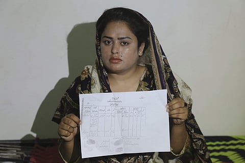 Pakistani Christian Natasha Masih shows her marriage certificate during an interview in Faisalabad, Pakistan. (Photo | AP)