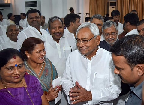 Bihar Chief Minister Nitish Kumar along with deputy CM Sushil Kumar Modi during the swearing-in ceremony for the cabinet expansion of coalition government of NDA in Patna Sunday June 2 2019. | PTI