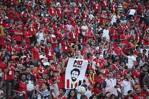 Egyptian fans hold a poster of their star Mohamed Salah | AP