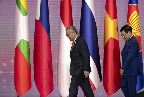 Thailand's Foreign Minister Don Pramudwinai, left, and Vietnam's Foreign Minister Pham Binh Minh walk for a group photo during the 34th ASEAN summit.