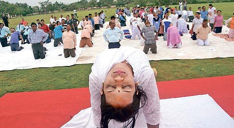 An instructor teaching asana on Utkal University  campus. ( Photo | EPS)