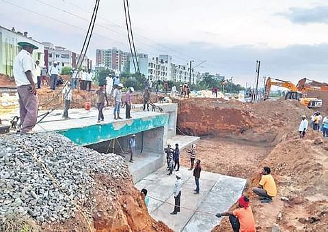 Precast reinforced concrete cement boxes  being placed between Guduvanchery and Vandalur railway station on Saturday | Express