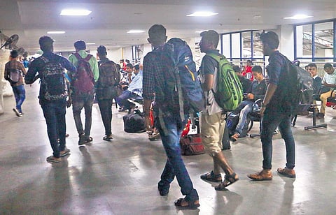 Disappointed passengers return from the KSRTC bus terminus in Kozhikode after finding no bus tickets were available to Bengaluru on Monday  | T P Sooraj