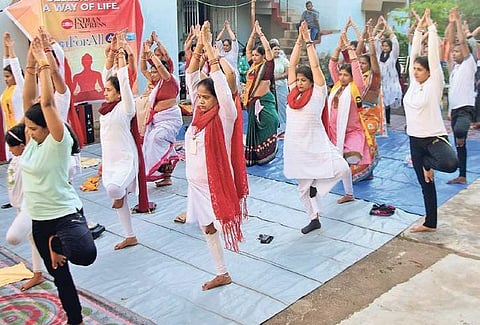 Inmates of Krishna Anand Ashram, an old age home, perform an asana along with volunteers during a Yoga session in Bhubaneswar on Monday. ( Photo | EPS)