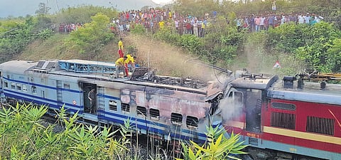 Fire personnel engaged in dousing fire in Samaleswari Express. ( Photo | EPS)
